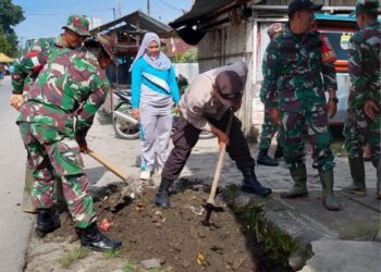 Camat Dolok Batunanggar, Siti Aminah Siregar (baju olahraga), bersama personel Koramil Serbelawan, Polsek, dan warga bergotong royong membersihkan parit di Kelurahan Aman Sari, Kecamatan Dolok Batunanggar, Simalungun.(Simantab/ist)