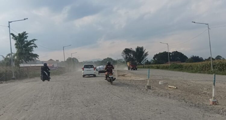 Sejumlah pengendara melintas di ruas Jalan Outer Ringroad Siantar yang tengah dalam tahap pengerasan base course.(Simantab/Putra Purba)